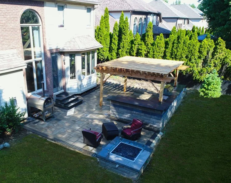 Pergola, paver patio and fire pit designed and built by ZLM Outdoor Living in Michigan