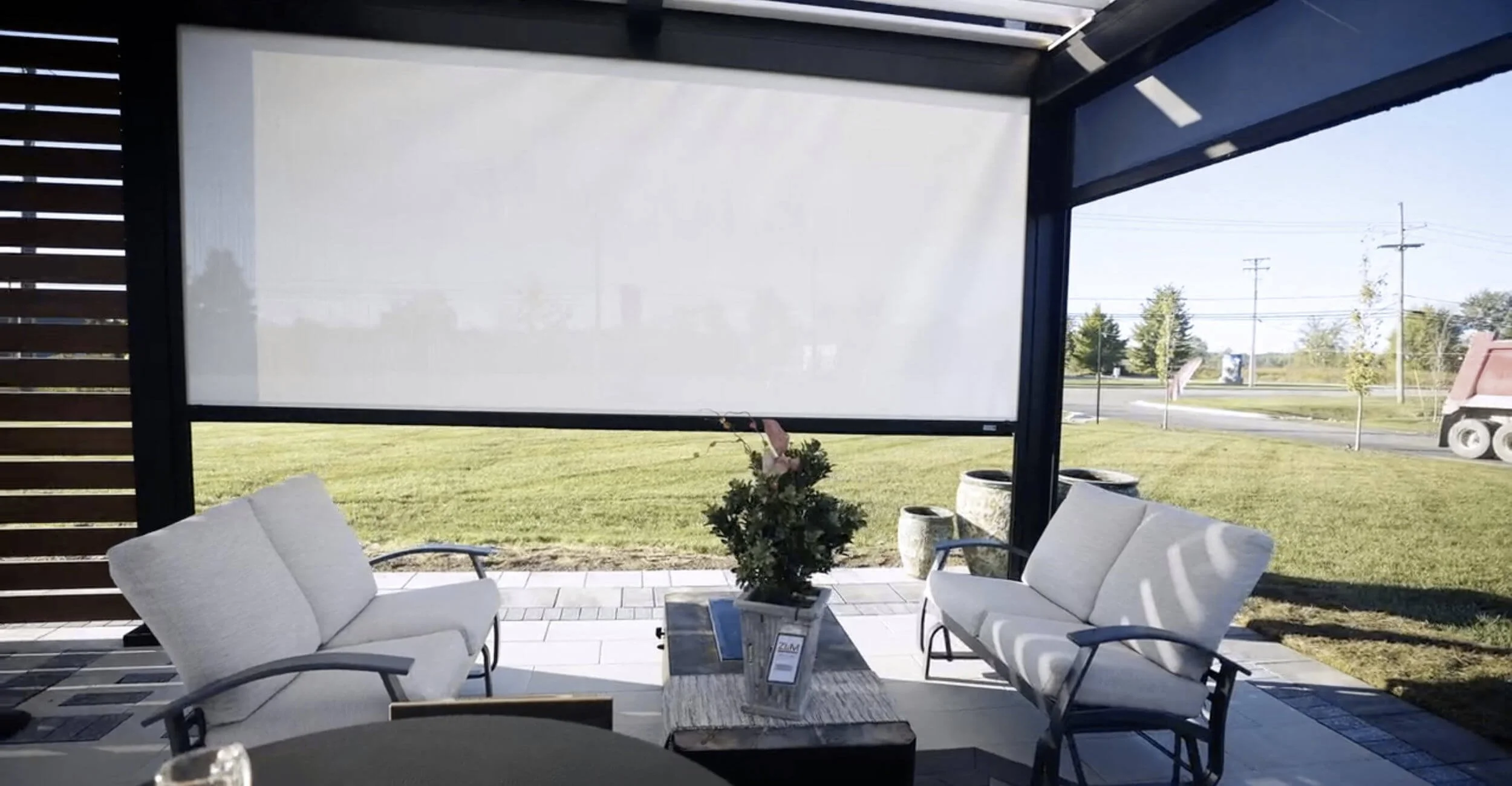 Outdoor pergola with shades at the outdoor living showroom in Troy, Shelby Township, and Rochester Hills, MI