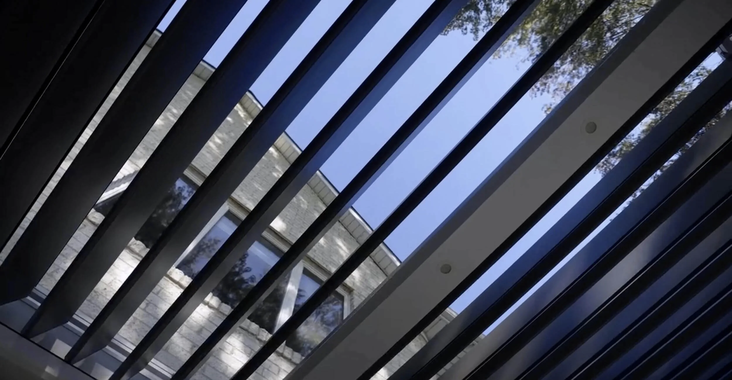 Motorized R-Blade pergola installed for three season outdoor living in Troy, Shelby Township, and Rochester Hills, MI with adjustable louvered roof