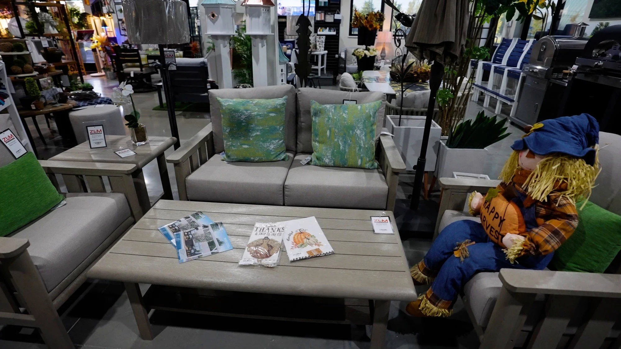 Outdoor living showroom section with sofas, lounge seating, and accessory displays