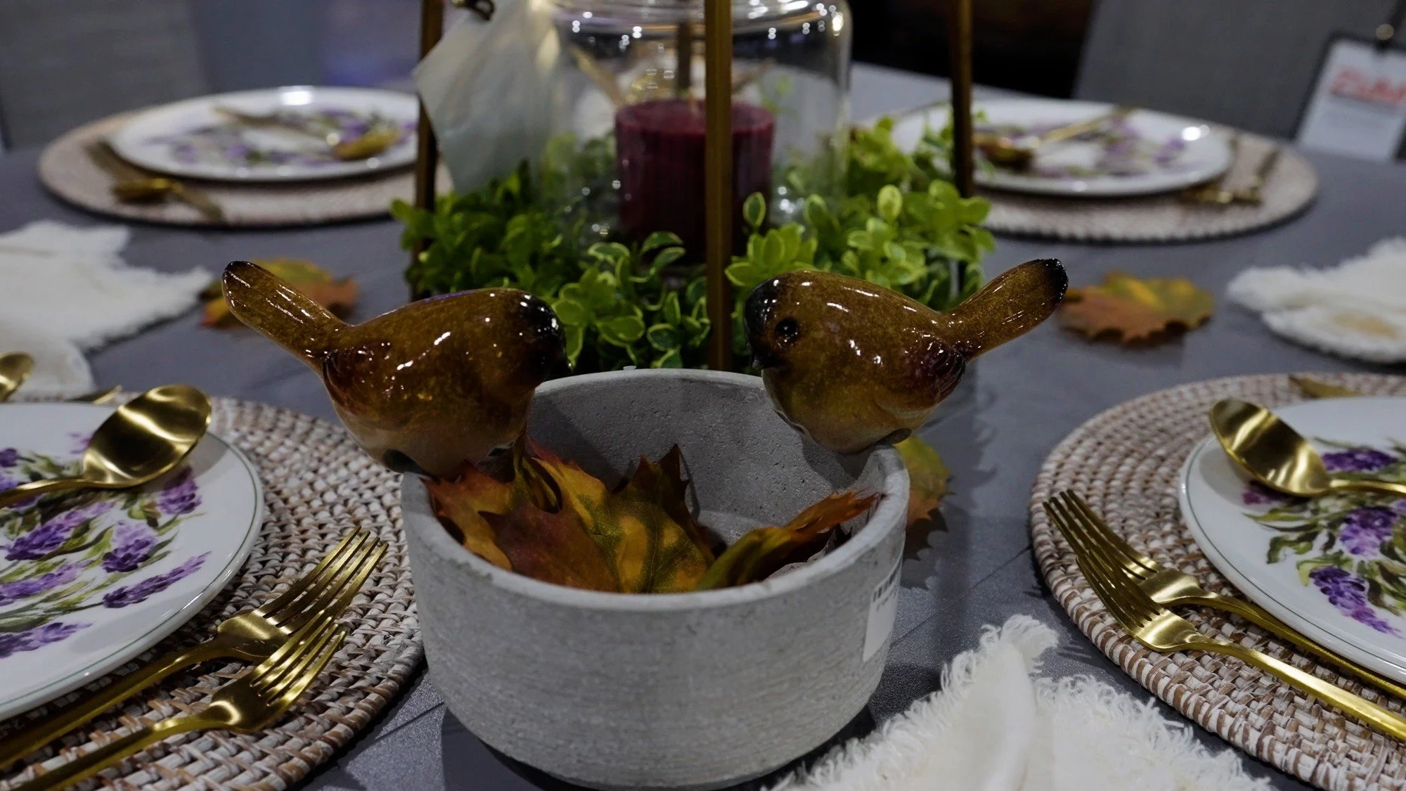 Close-up of decorative bowls, moss, and tabletop accessories in the showroom
