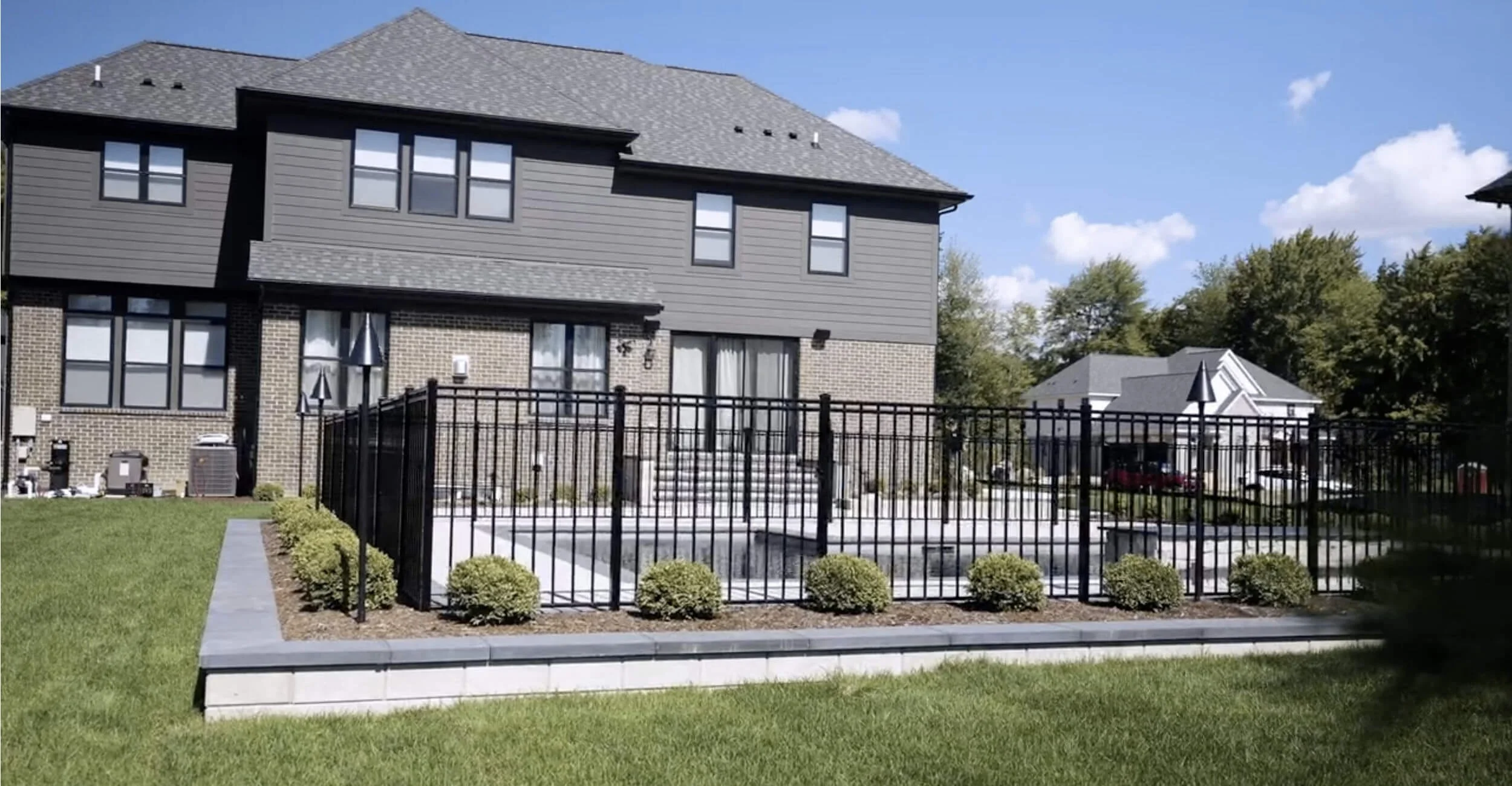 Resort-style outdoor space highlighting precision custom pool design in Troy, Shelby Township, and Rochester Hills, MI and expansive patio layout