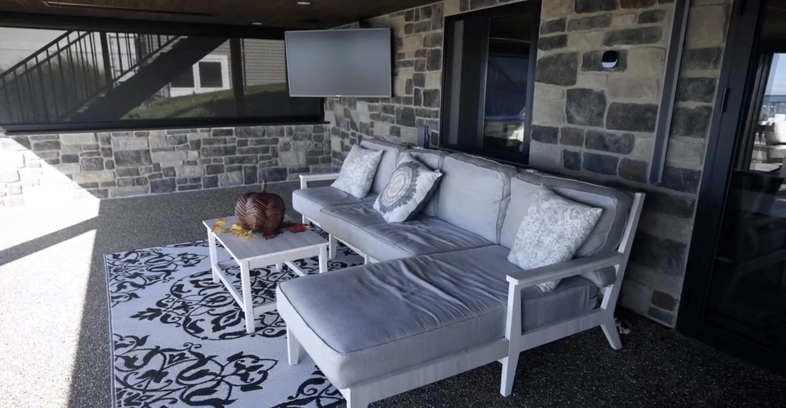 Outdoor lounge zone crafted as part of a comprehensive backyard oasis design in Troy, Shelby Township, and Rochester Hills, MI