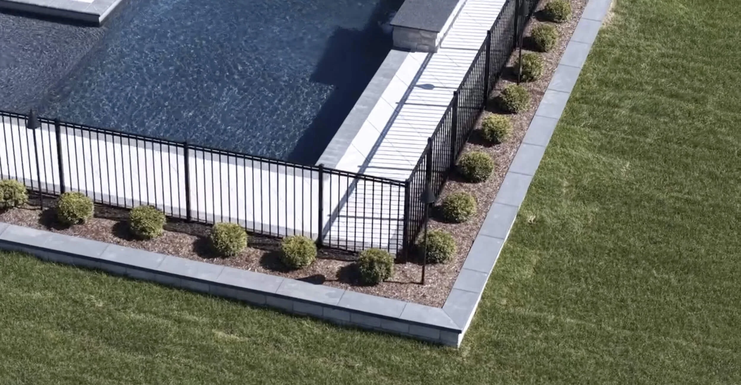 Modern rectangular pool illustrating detailed custom pool design in Troy, Shelby Township, and Rochester Hills, MI paired with sleek landscaping