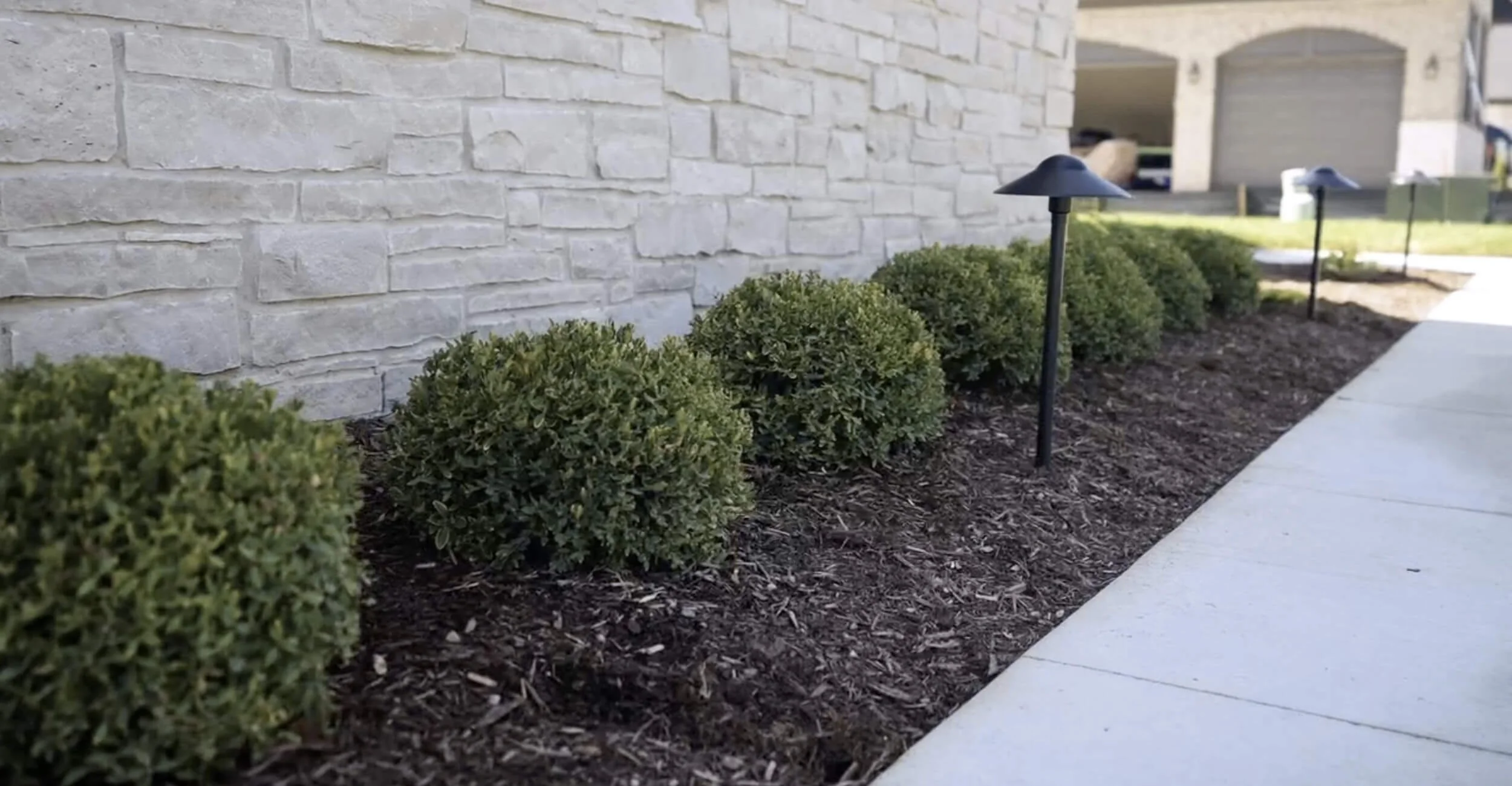 Private outdoor sanctuary built around custom pool design in Troy, Shelby Township, and Rochester Hills, MI with lush perimeter plantings