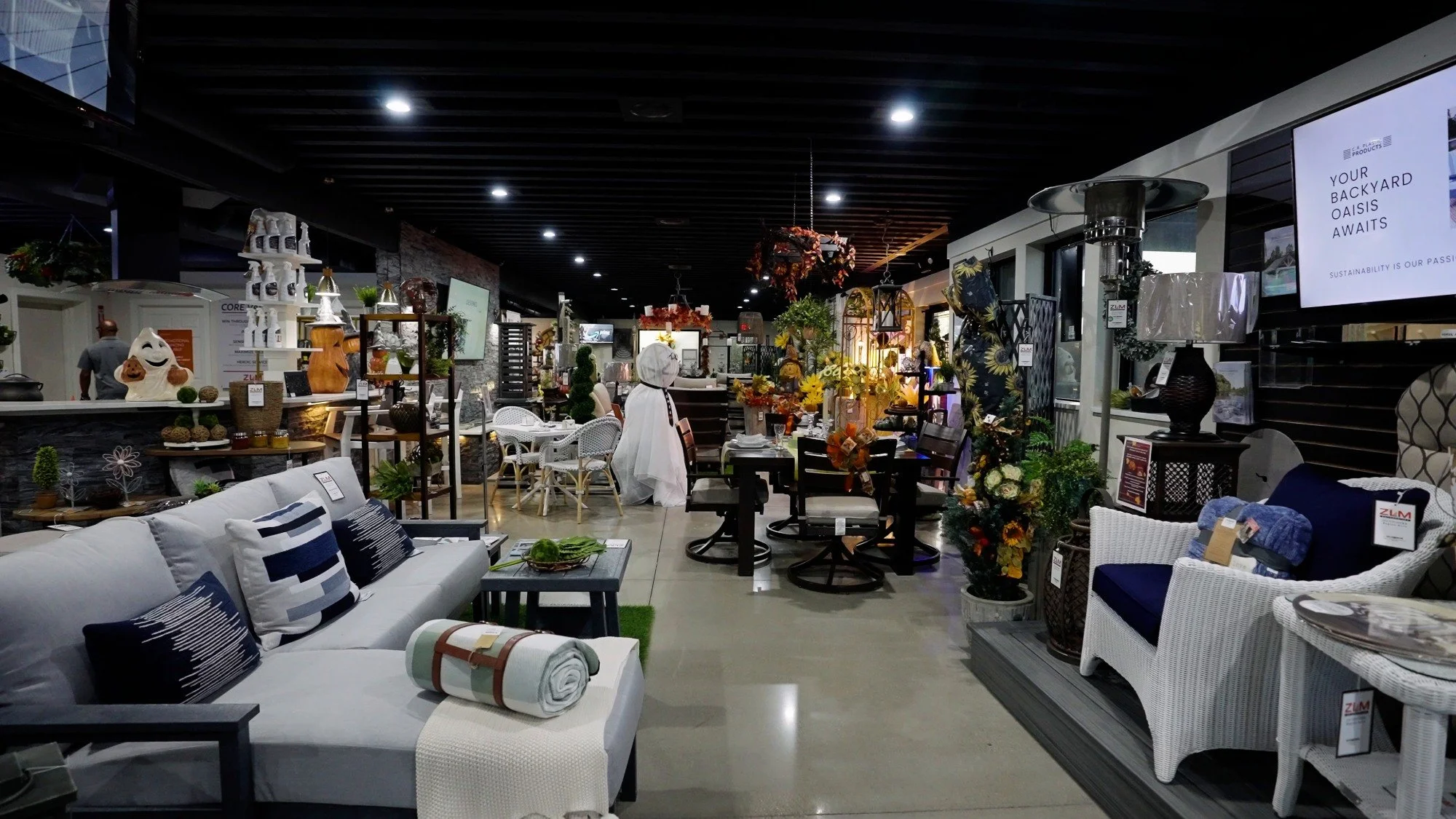 Indoor showroom display featuring outdoor furniture, decor, and lighting selections
