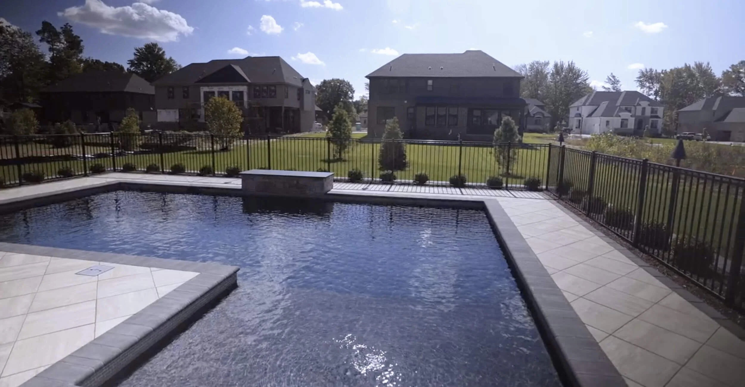 Contemporary swimming pool with clean lines showcasing innovative custom pool design in Troy, Shelby Township, and Rochester Hills, MI