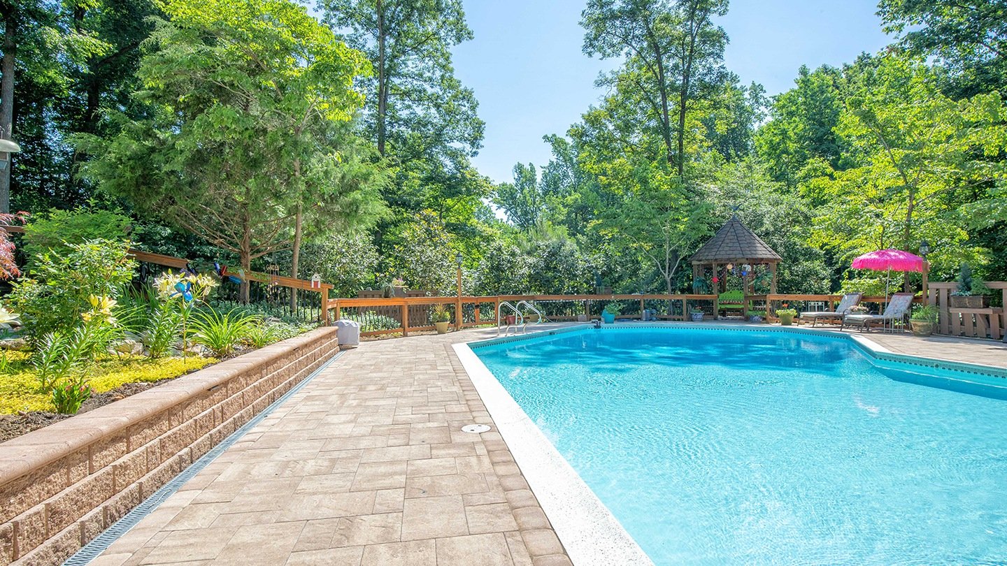 Stunning landscape design with retaining wall and poolscape in Wyndham, VA