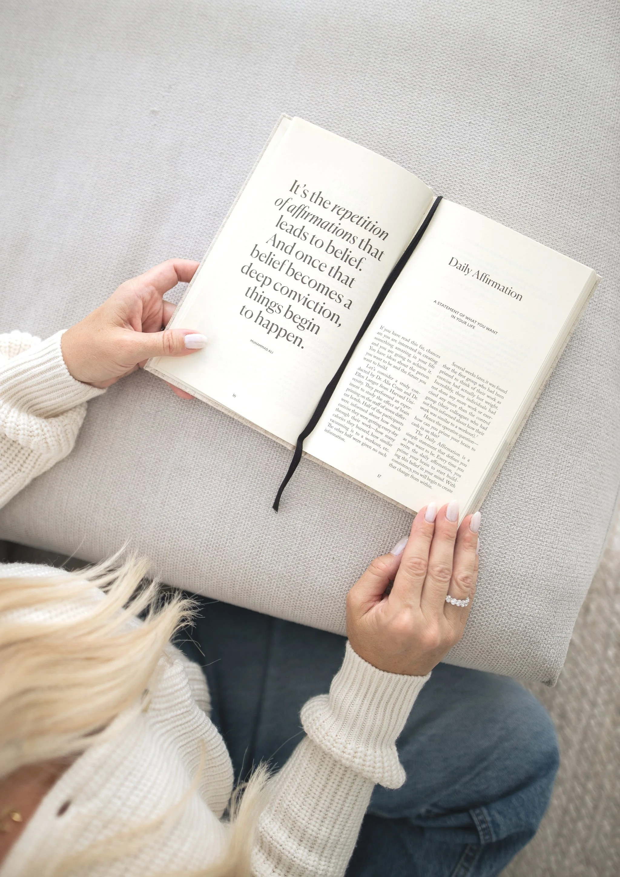 hands of a woman holding and reading a book