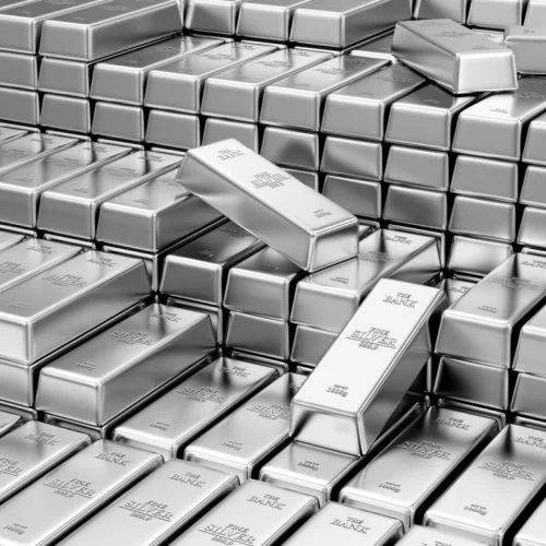 Numerous stacked silver bars with a few gold bars on top, some tilted and scattered.