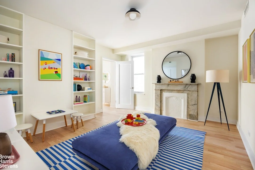 Children's playroom with brightly colored furniture and toys on the built in shelves