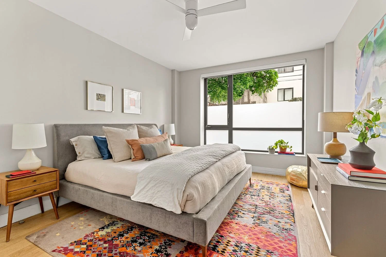 A colorful bedroom on the ground floor with metallic and red accents.
