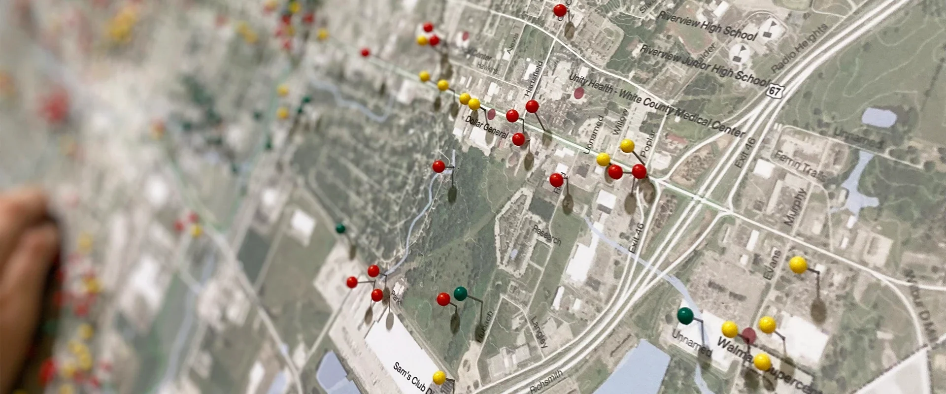 Map of White Court, Indiana, covered with colorful pushpins marking locations near schools, medical centers, and stores.