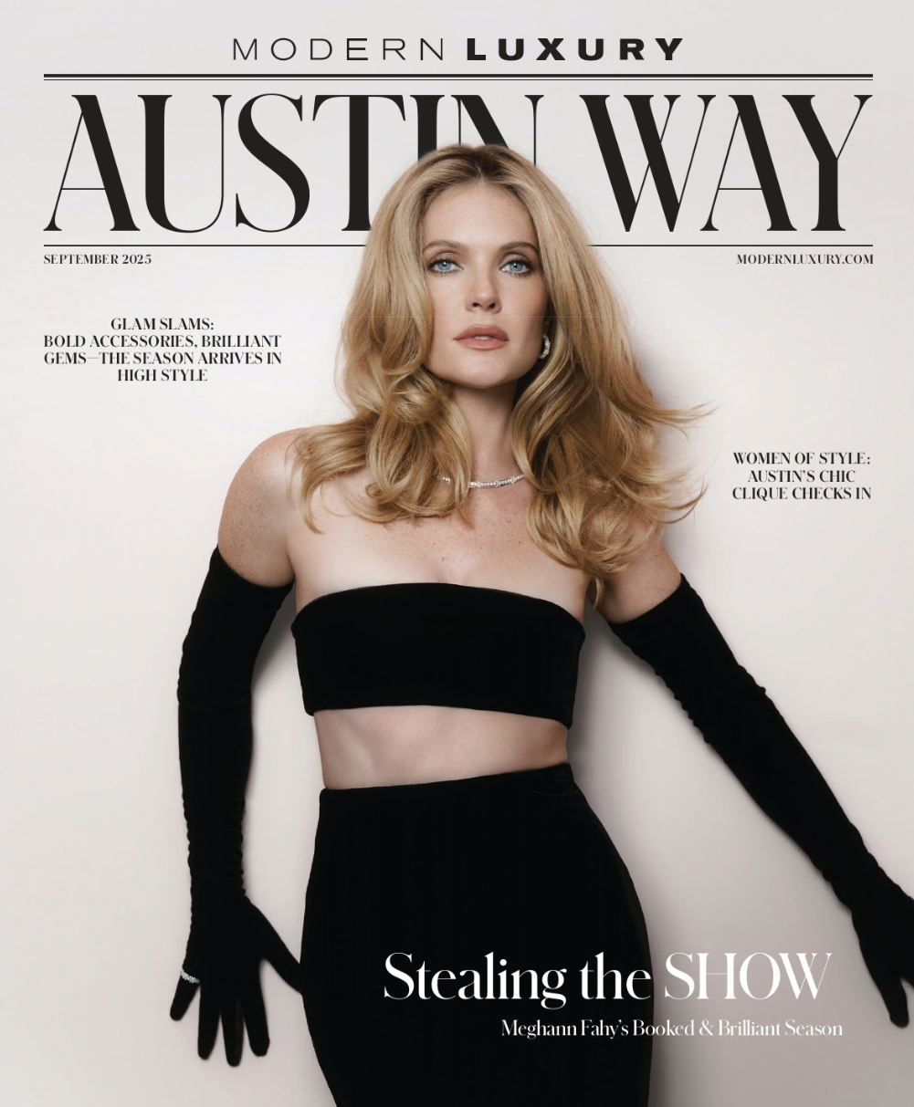 Magazine cover featuring a woman with long, wavy blonde hair, wearing a black strapless top and long black gloves, with the headline 'Stealing the SHOW' and text about Meghan Fahy's season.