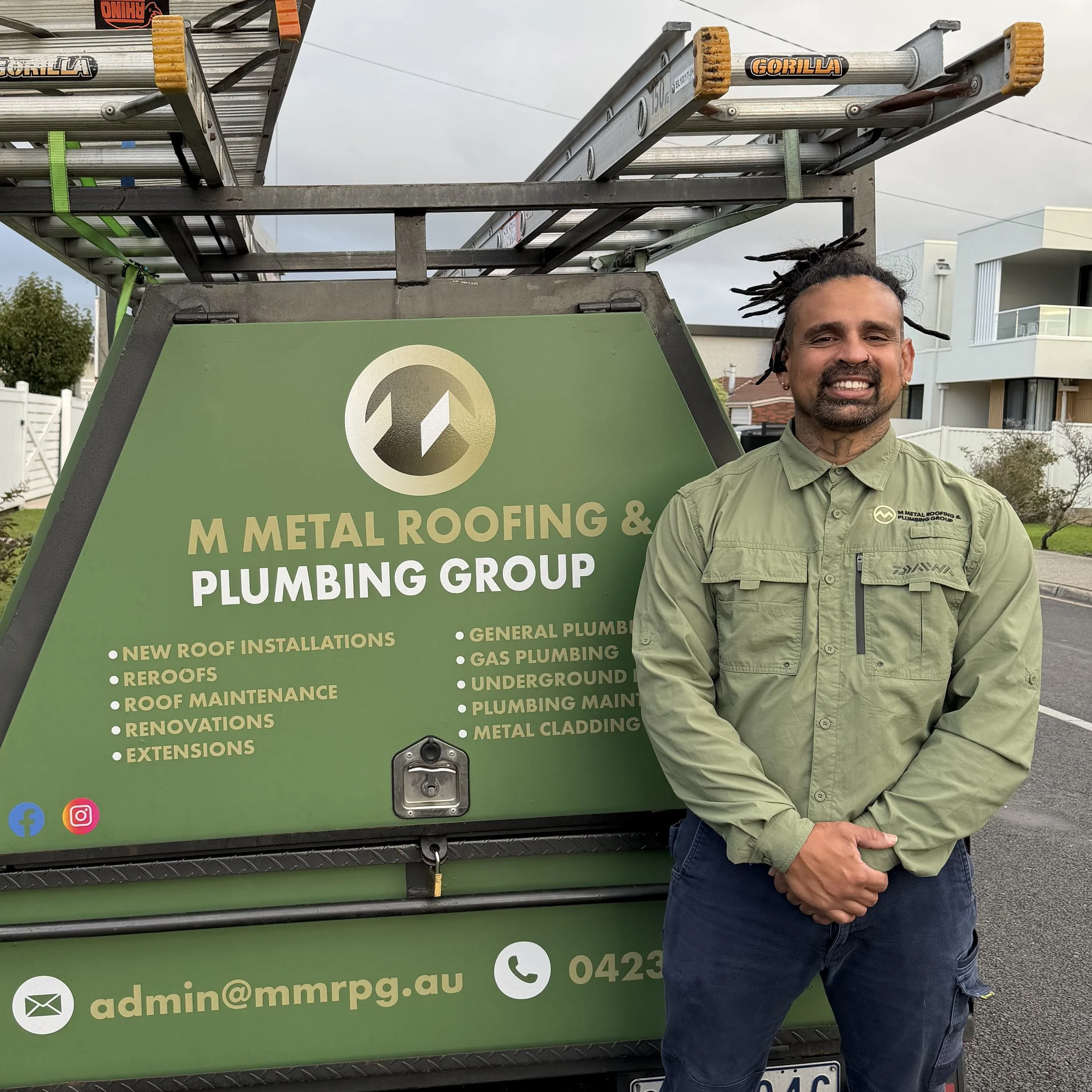 Max, owner of M Metal Roofing & Plumbing Group, beside the company's branded work trailer in Melbourne