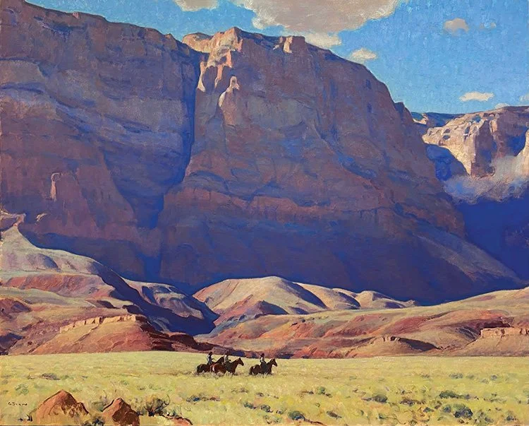A monumental landscape by artist Glenn Dean depict cowboys riding in the shadow of western mountain across a plain of golden brush.
