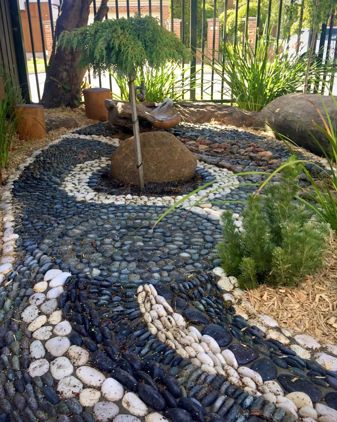 Nooks is what we call them. 
Little spaces tucked away from the busyness, where rest, respite and curiosity can be found. Here we have rounded pebbles of varying size and shape embedded in a concrete base. Beautifully designed to evoke inquisitive mi