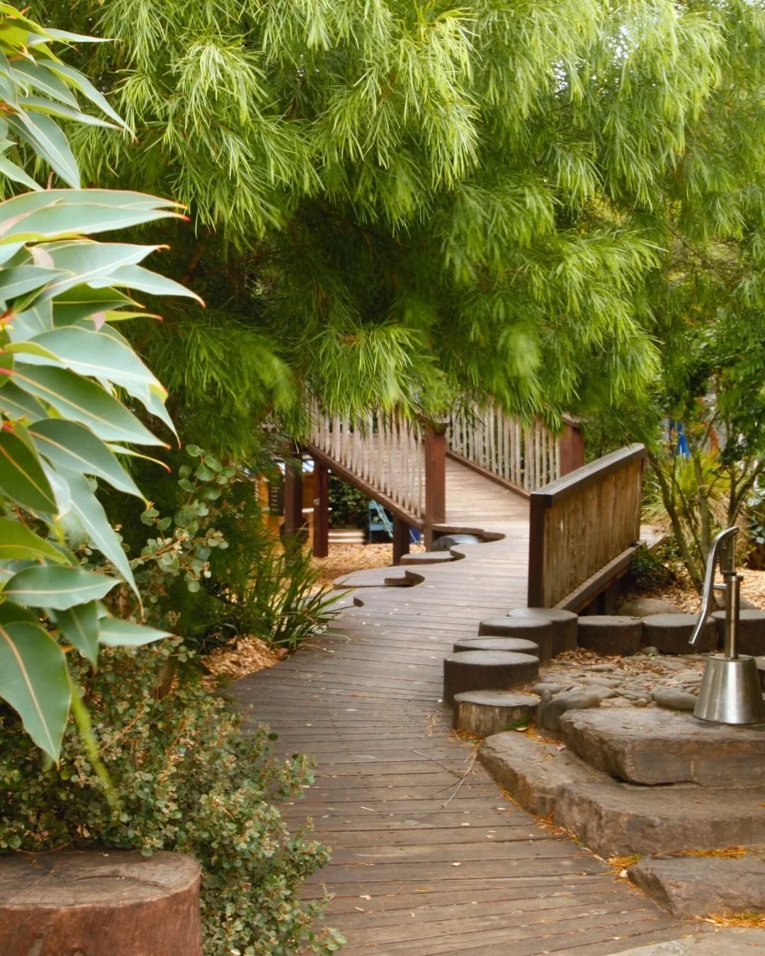 Just a quiet moment. In a busy Children&rsquo;s Garden. 

Access can be playful and whimsical, as well as practical and functional. 

Landscaping can provide habitat for local wildlife, as well as science lessons. 

Shade can cool the playground and 