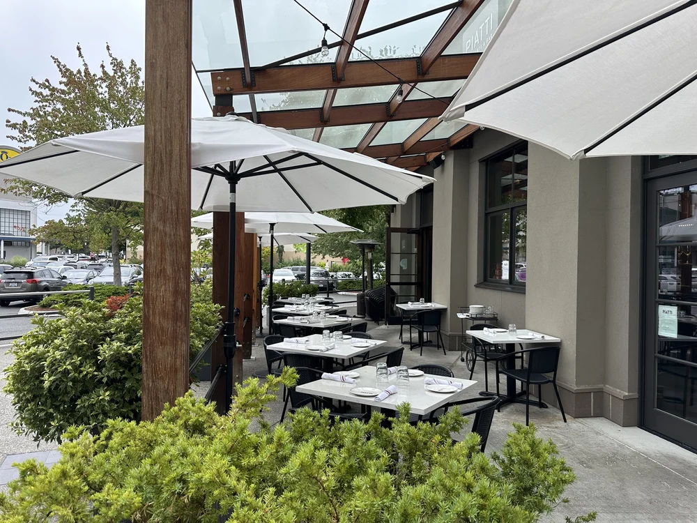 La Serra covered patio at Piatti Seattle with umbrellas and tables set