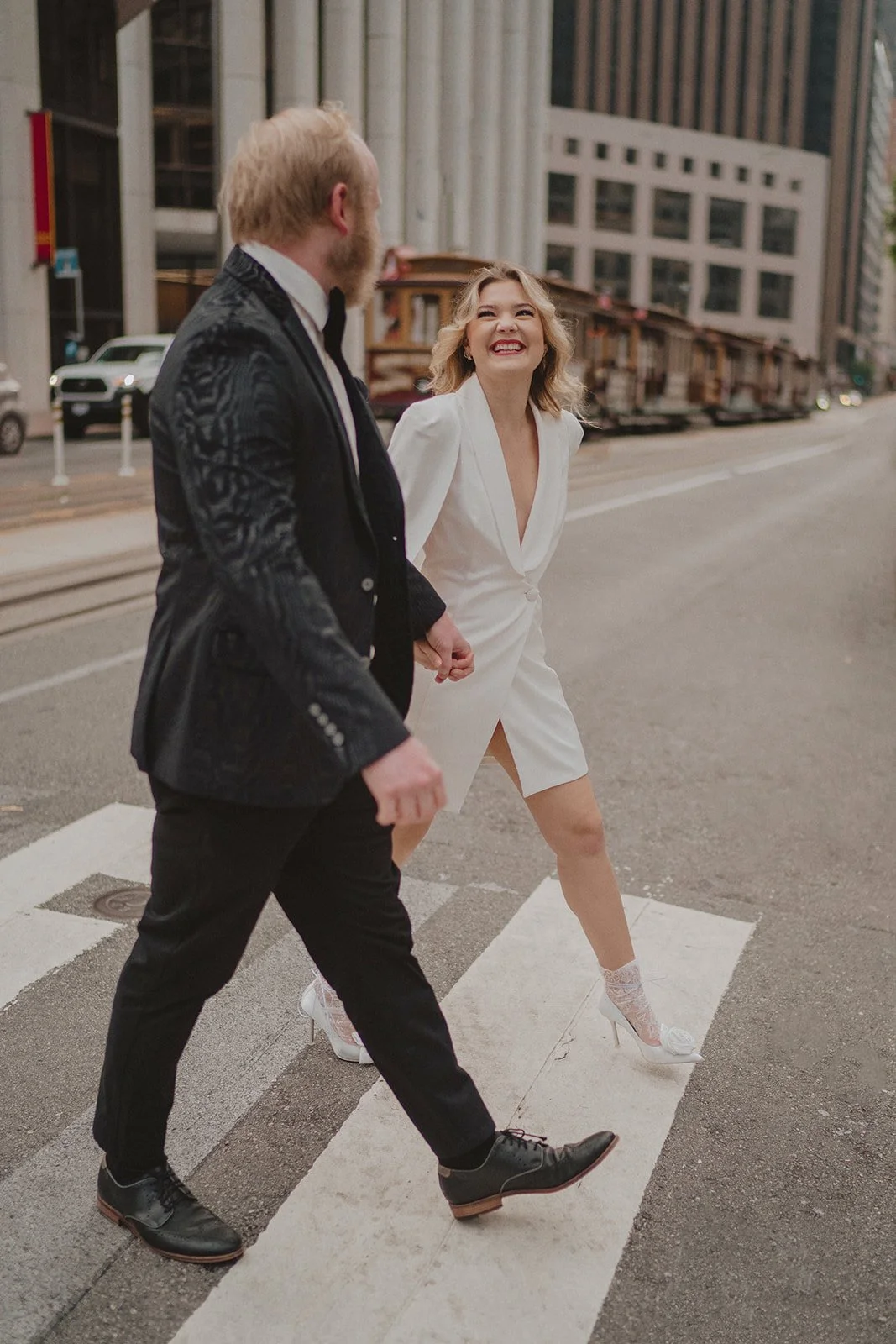 Couple walking across street, documented by san francisco city hall wedding photographer​