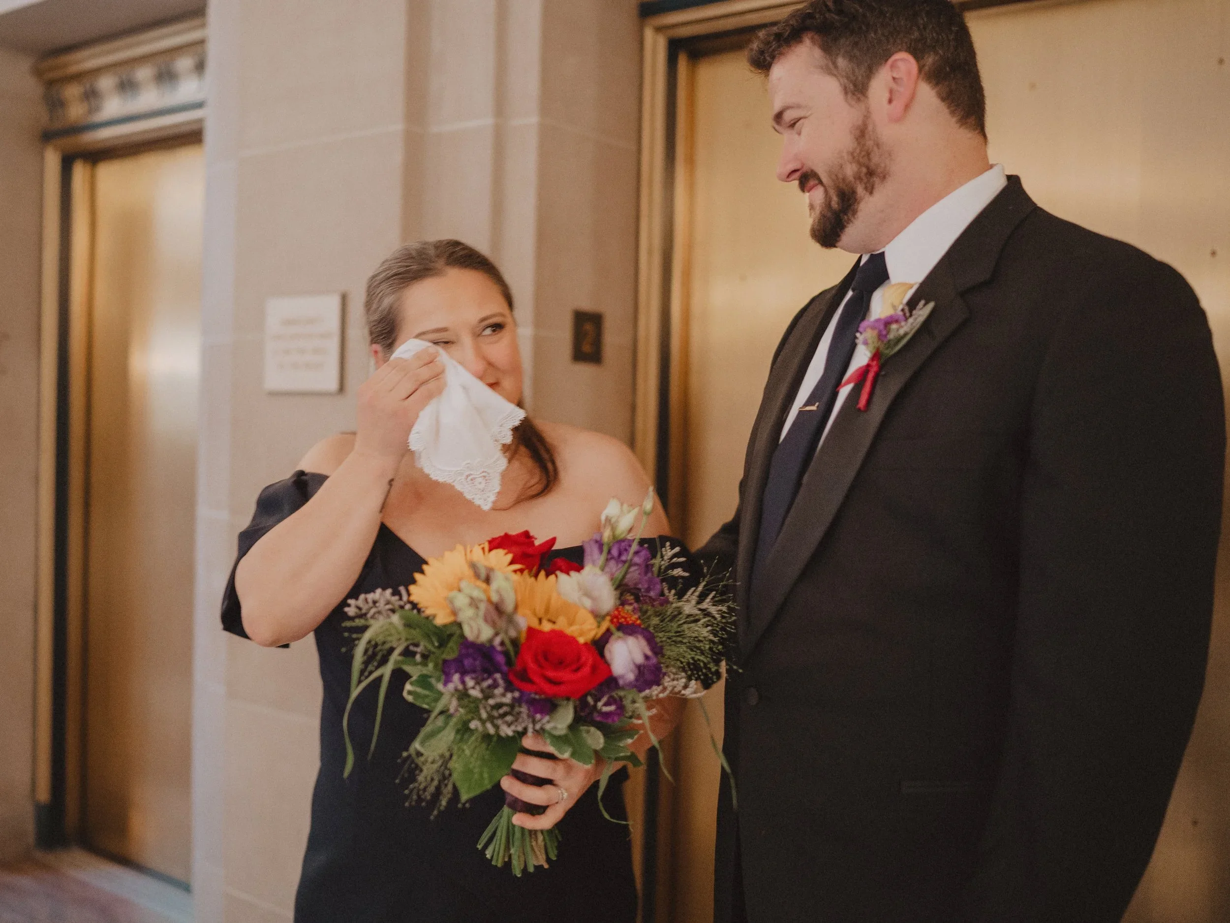 Woman crying and looking at her partner after wedding photographed by one of the top san francisco city hall wedding photographers​