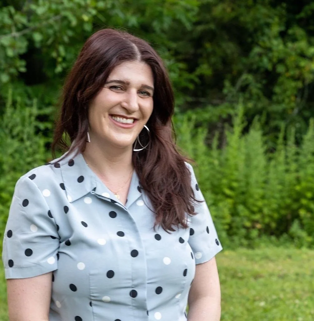 Headshot of Lily Duffy Against a Background of Lush Green Plants