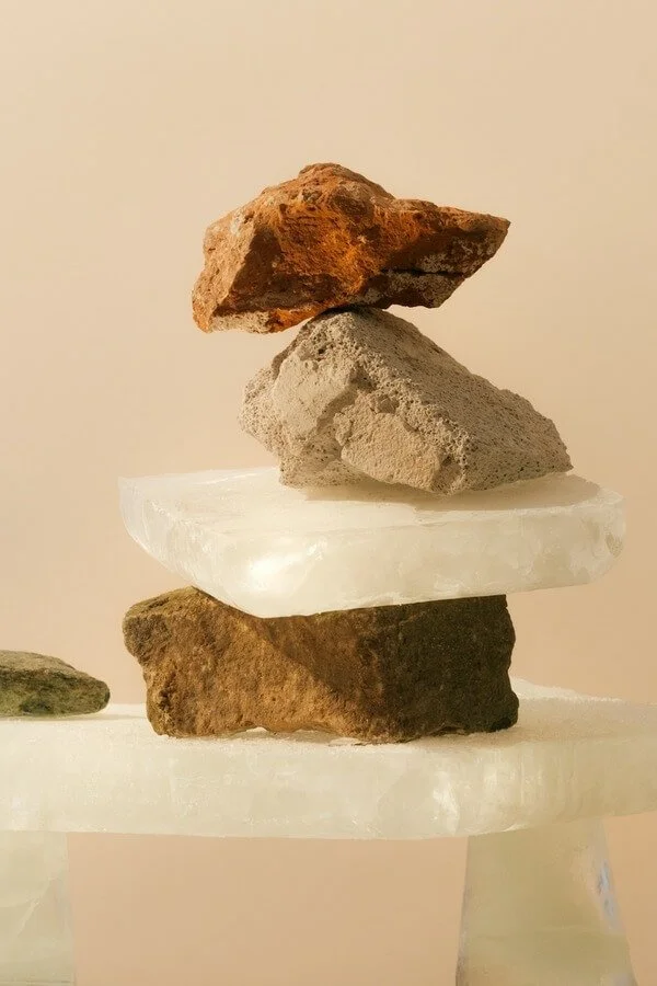 Rocks in various earth-tone colors stacked and balanced atop one another