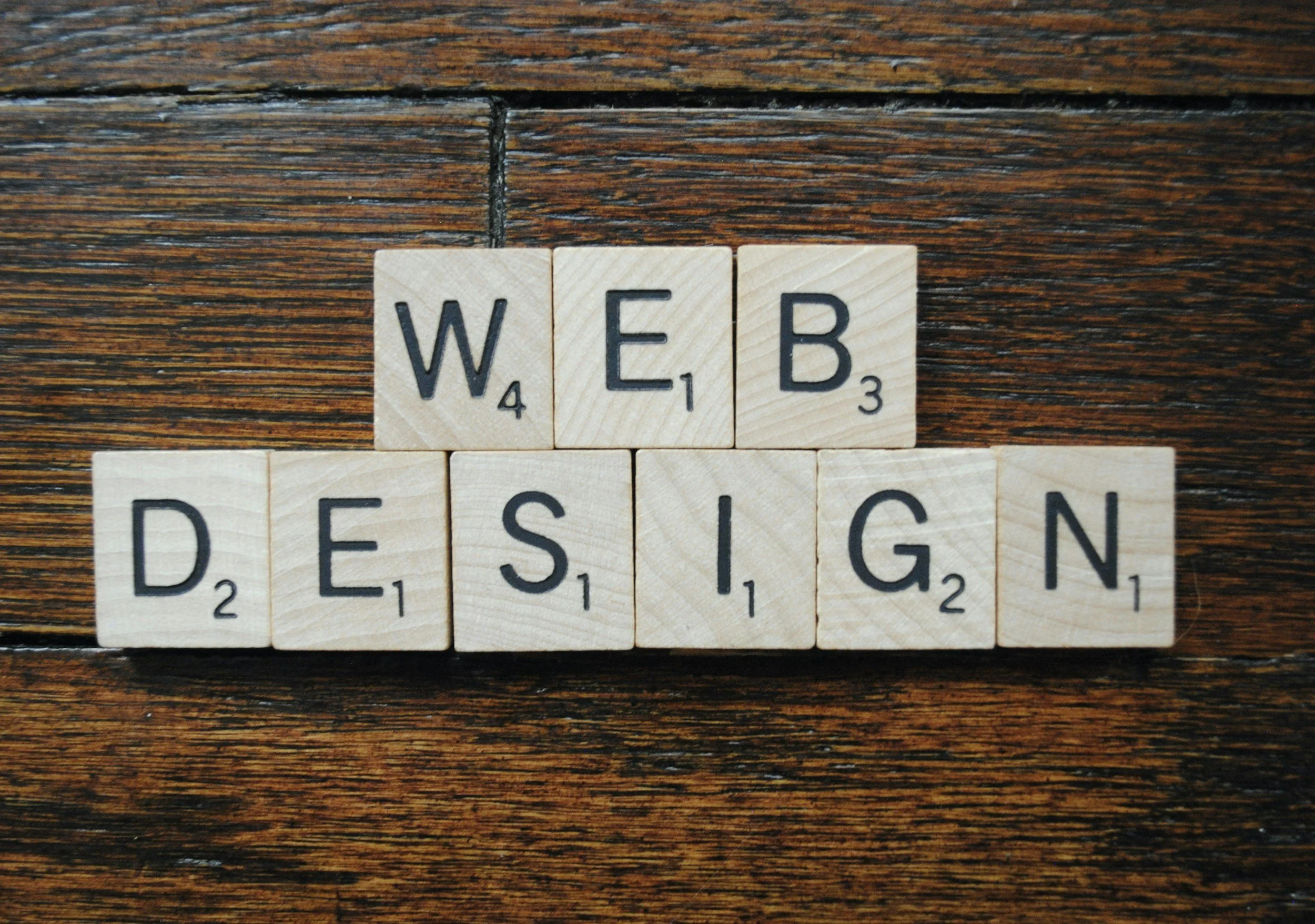 Wooden "Scrabble" style tiles spelling out "Web Design".