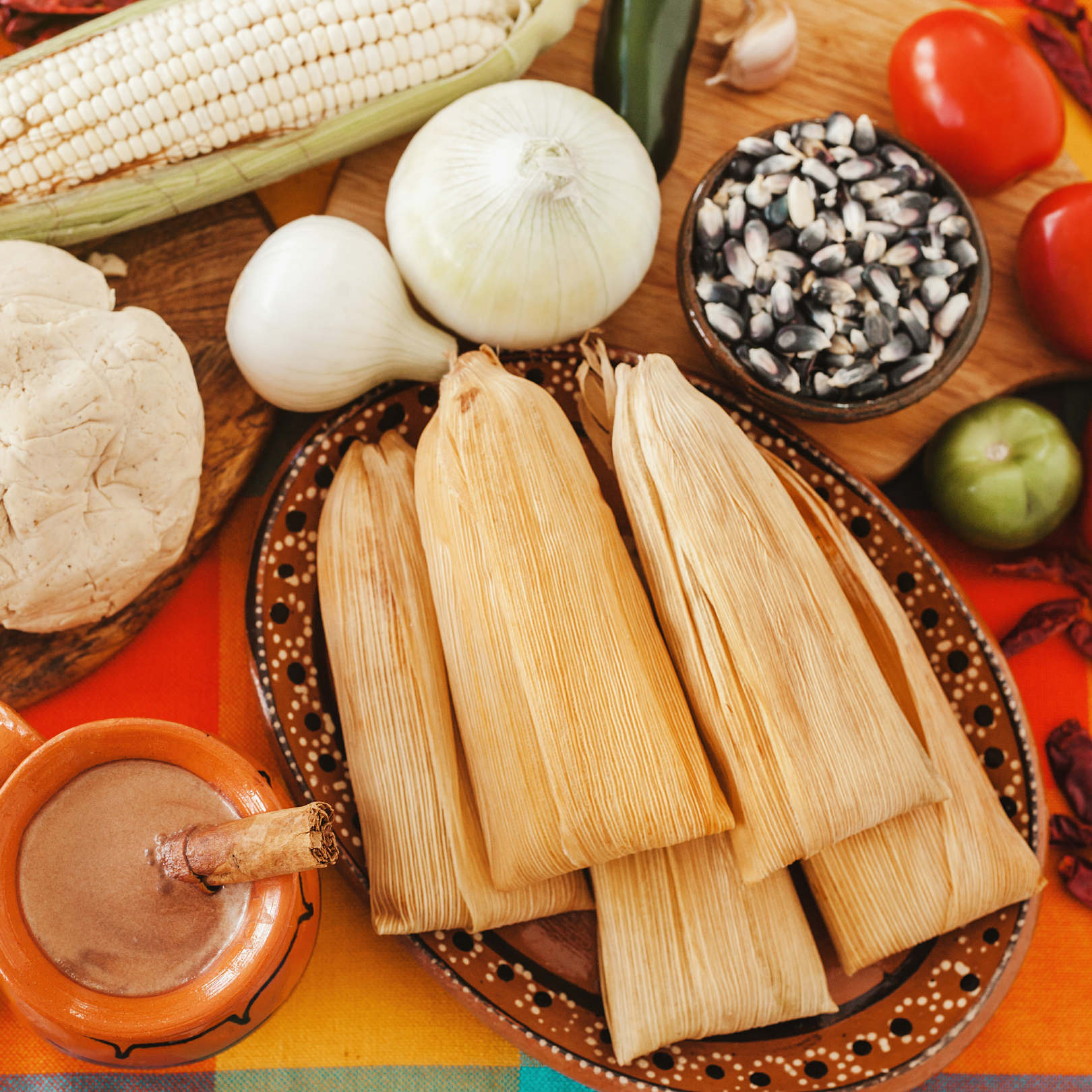 A picture of tamales surrounded by ingredients.