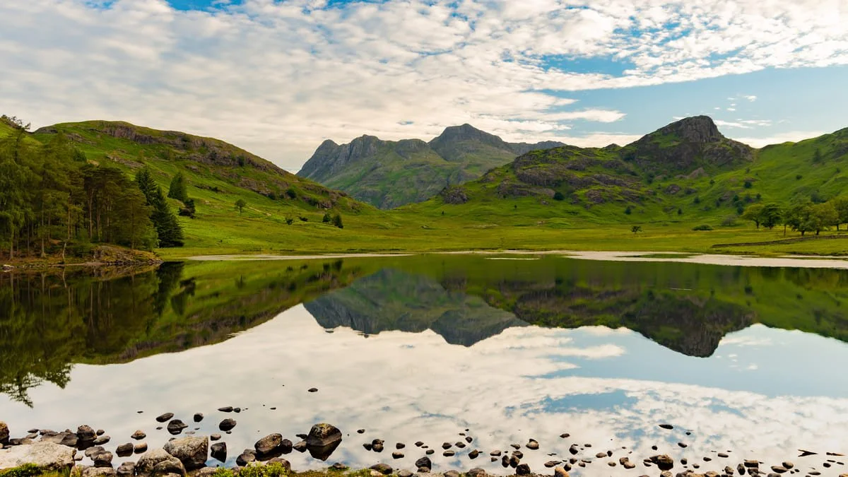 A summer morning on the shore of Blea Tarn with the reflection of the Langdale Pikes and Side Pike.