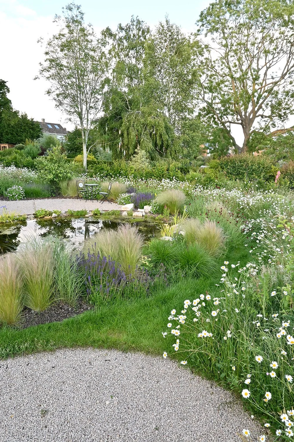 robert-johnson-garden-design-Cambridgeshire-pond-natural-grasses-gravel-seating-area.jpg