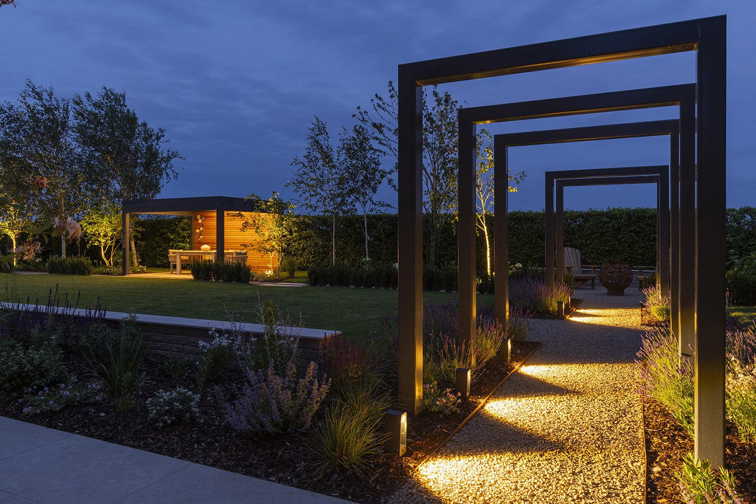 robert-johnson-garden-design-Lincs-outdoor-lighting-metal-arches-gravel-path-pergola.jpg