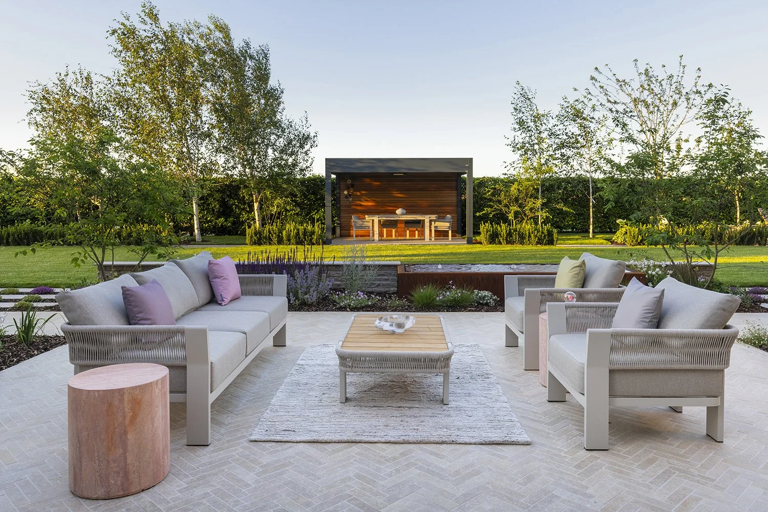 robert-johnson-garden-design-Lincs-herringbone-stone-paving-seating-outdoor-sofa.jpg