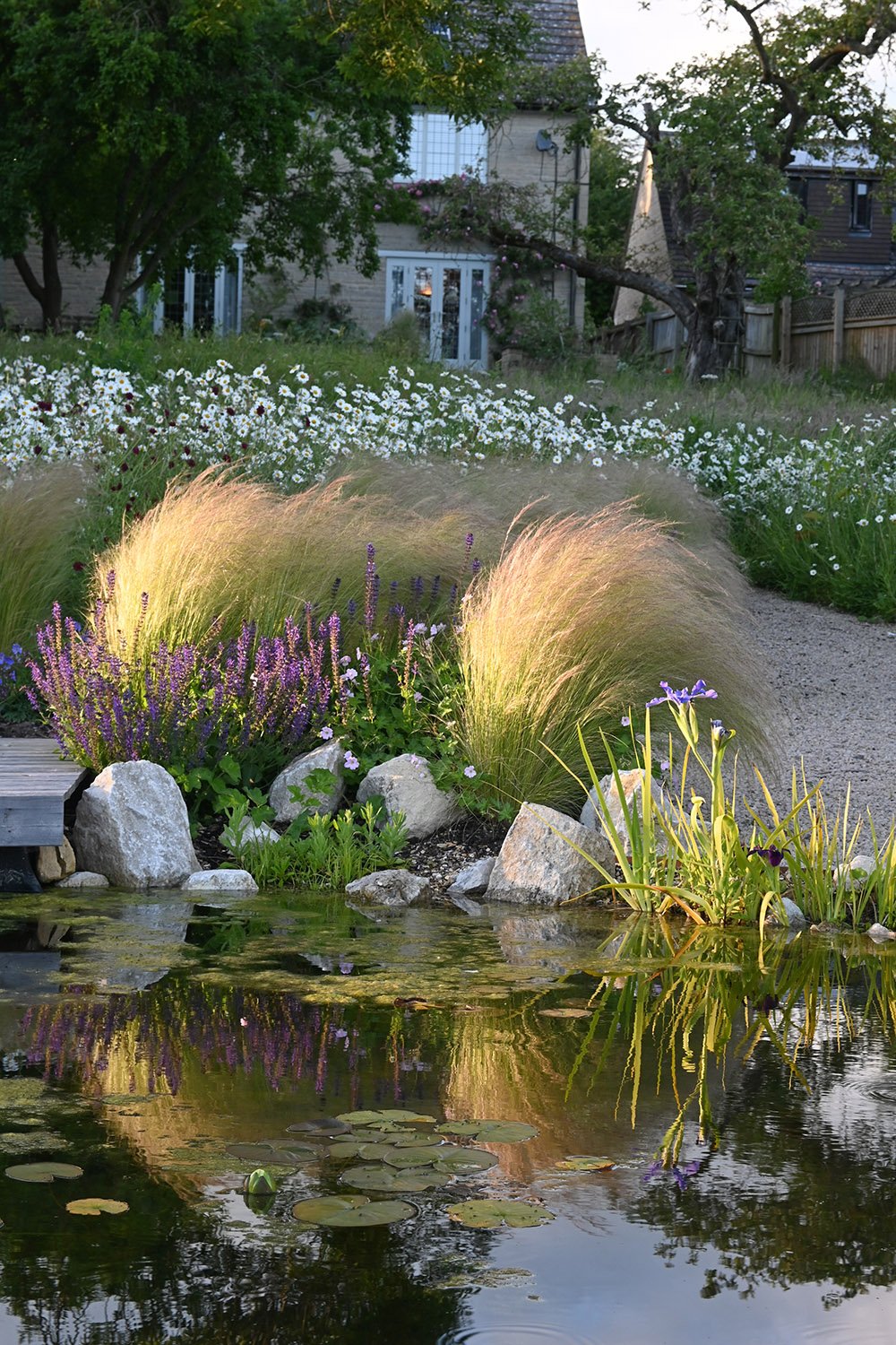 robert-johnson-garden-design-Cambridgeshire-lake-boulder-features-soft-grasses-iris-wildflower.jpg