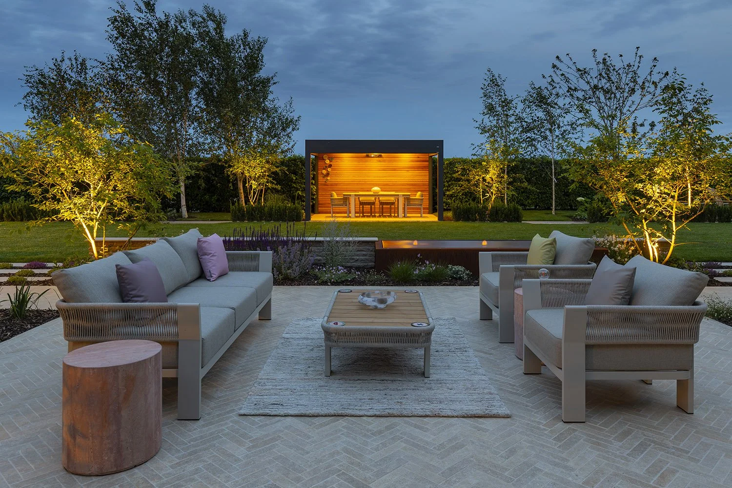 robert-johnson-garden-design-Lincs-illuminated-pergola-herringbone-paving-multistem-trees-outdoor-sofa.jpg