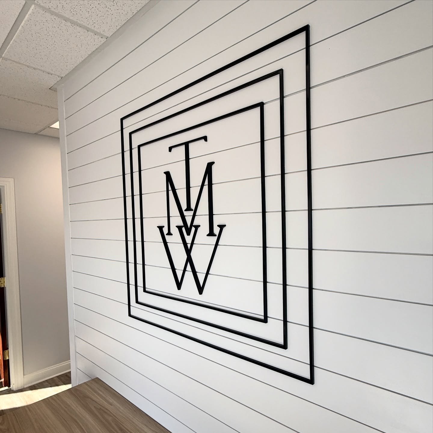 Take your logo and have us create a black acrylic display in your workspace for an elegant touch as your customers come through the doors. Very happy with how this one came out on a nice shiplap background!