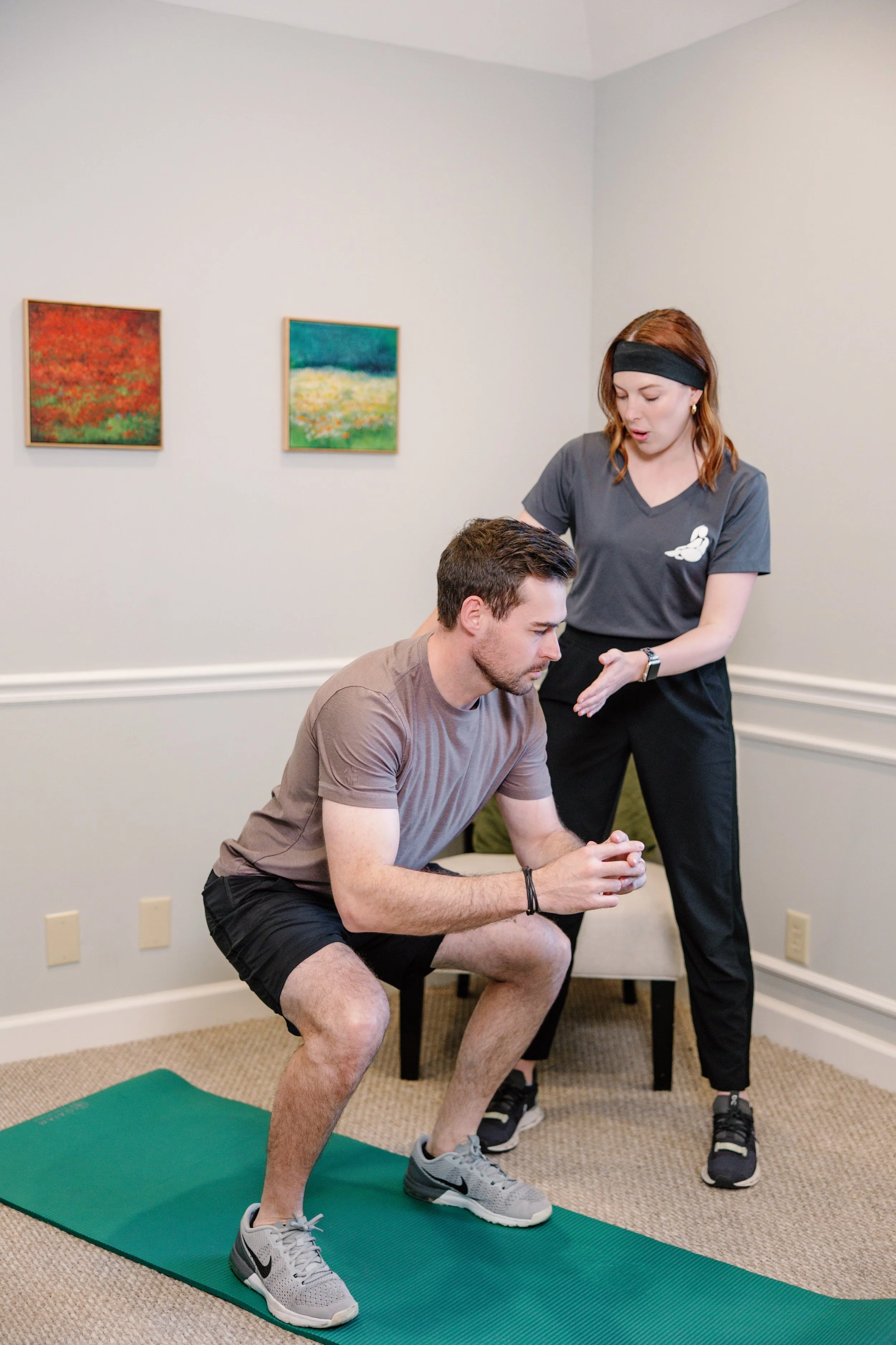 Male patient working with Pelvic Floor Therapist on proper squat technique.