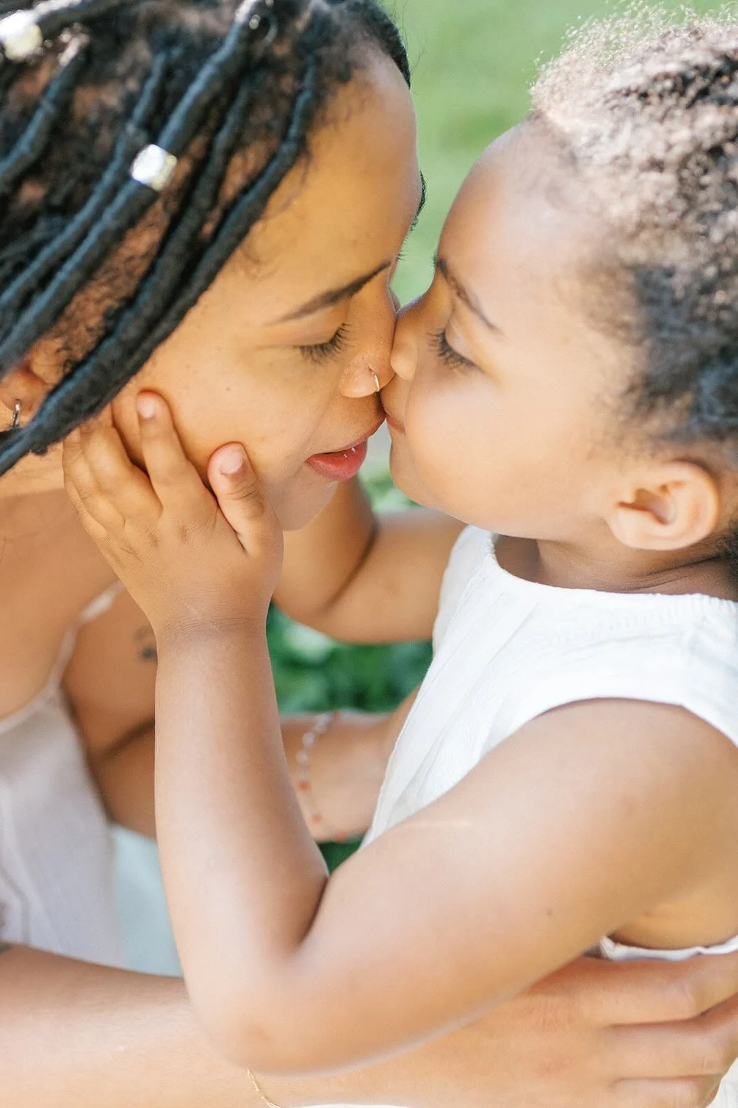 Daugher kissing mothers nose - Raleigh Newborn Photographer