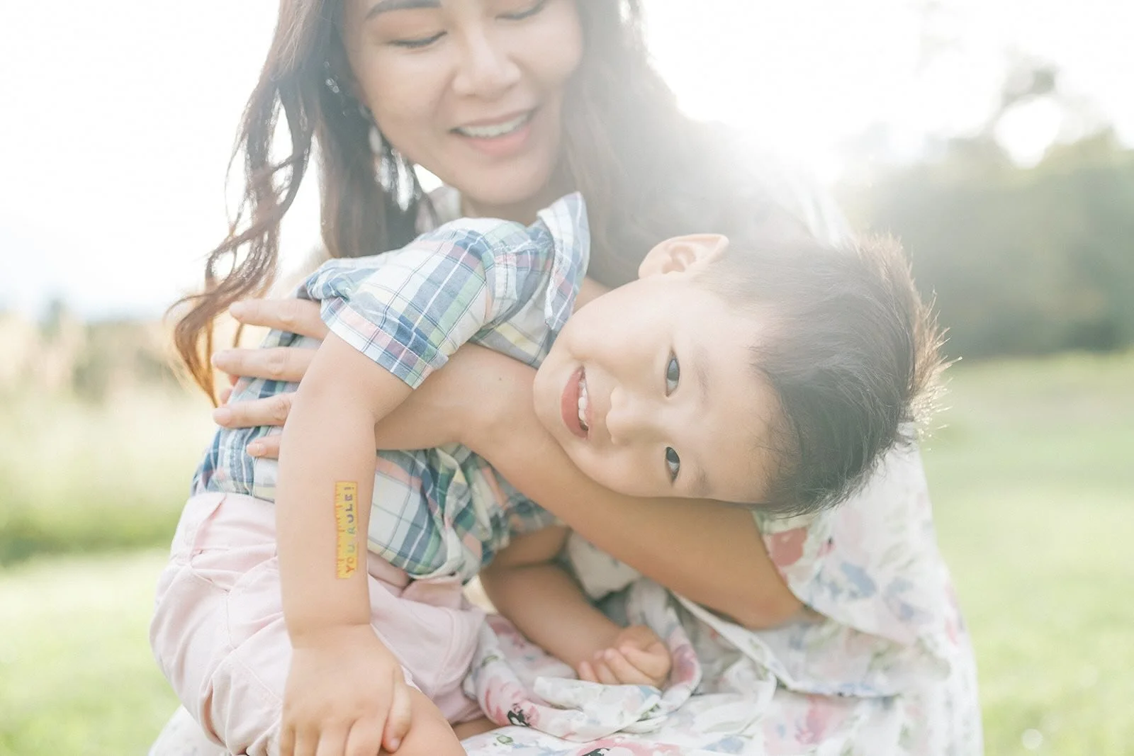 Mom holding smiling son in the sunlight - Raleigh Newborn Photographer