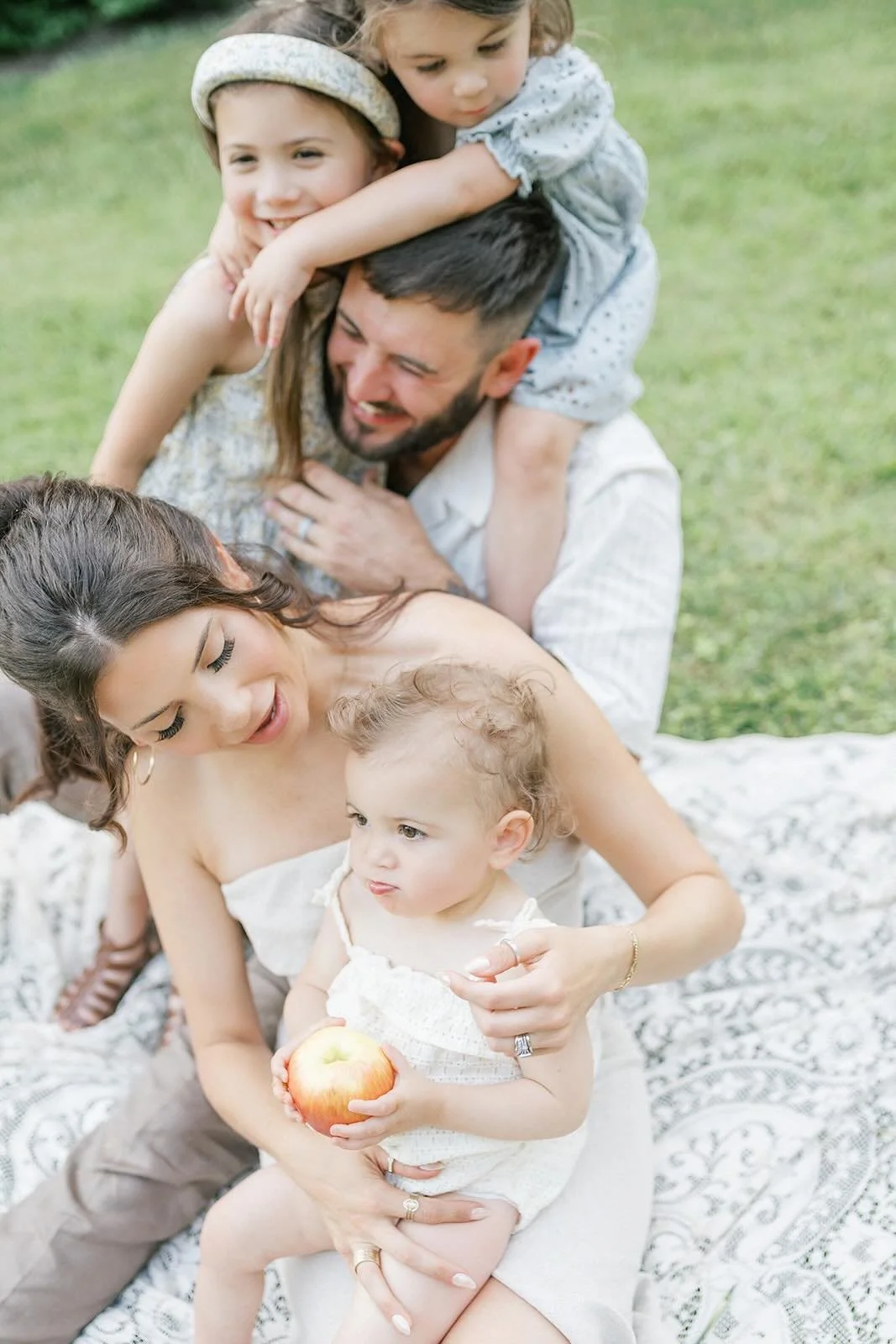 Mom and Dad with three children on a blanket outside - Raleigh Newborn Photographer