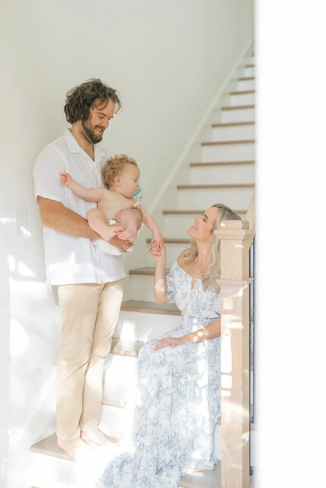 Family sitting on their steps in the natural light - Raleigh Newborn Photographer