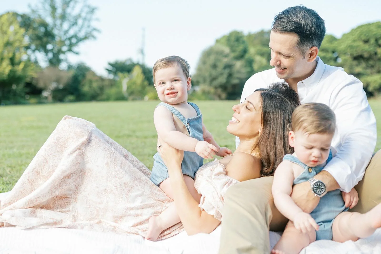 Family relaxing outside on a blanket - Raleigh Newborn Photographer