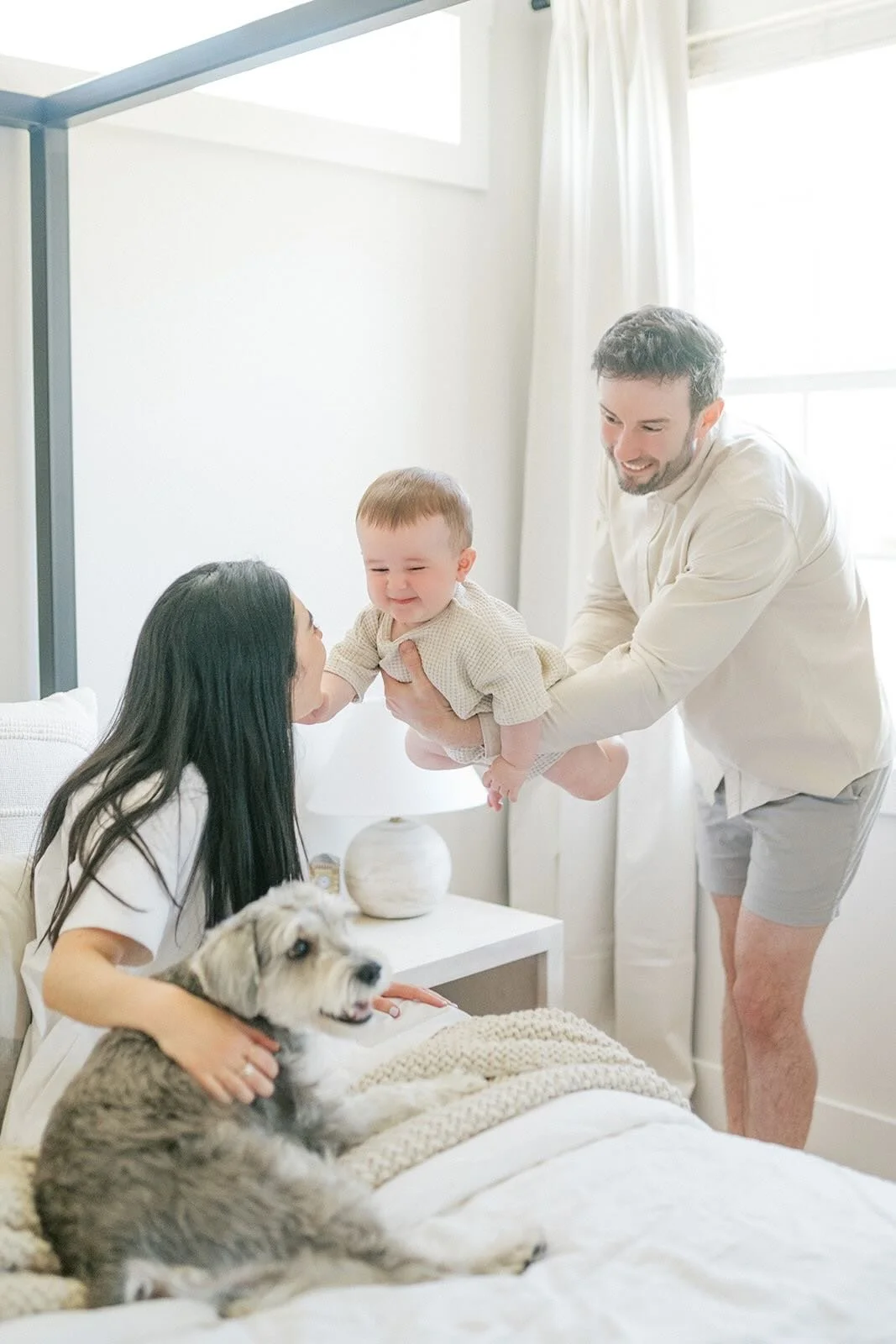 Dad flying son over to Mom - Raleigh Newborn Photographer