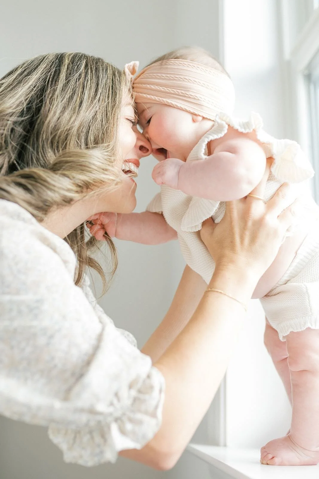 Mom and daughter nose kisses in the natural light - Raleigh Newborn Photographer