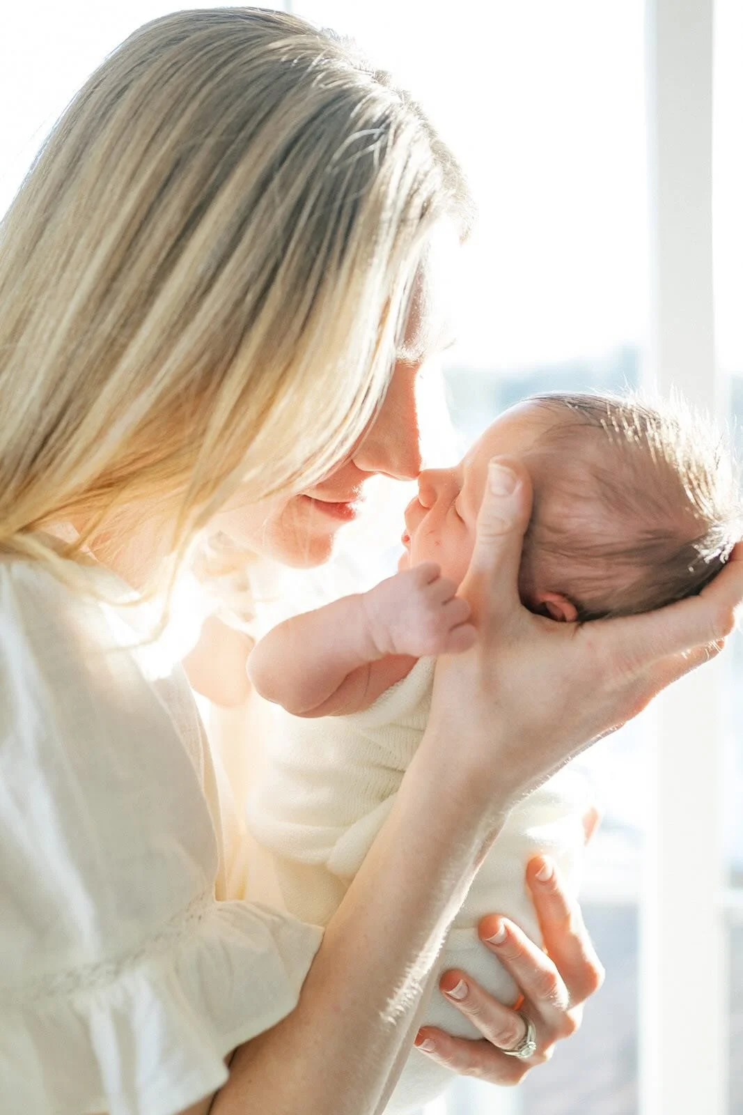 Mom nuzzling noses with baby - Raleigh Newborn Photographer