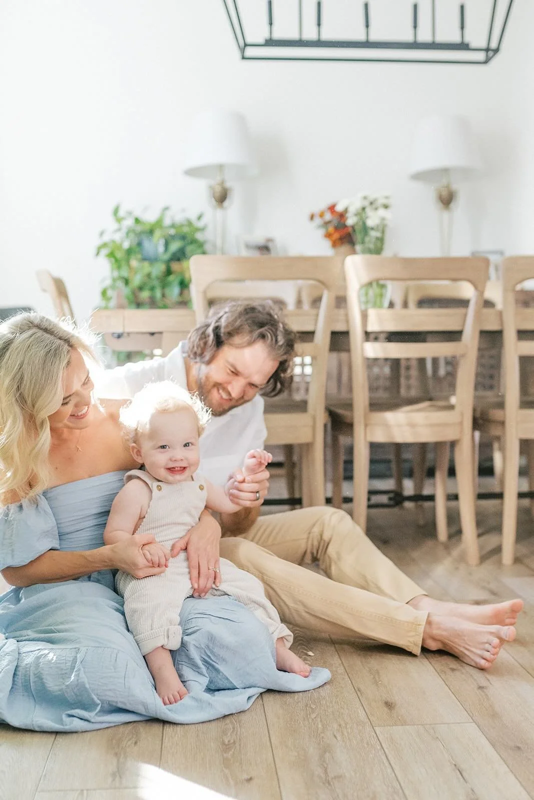 Mom and Dad holding baby in the kitchen - Raleigh Newborn Photographer