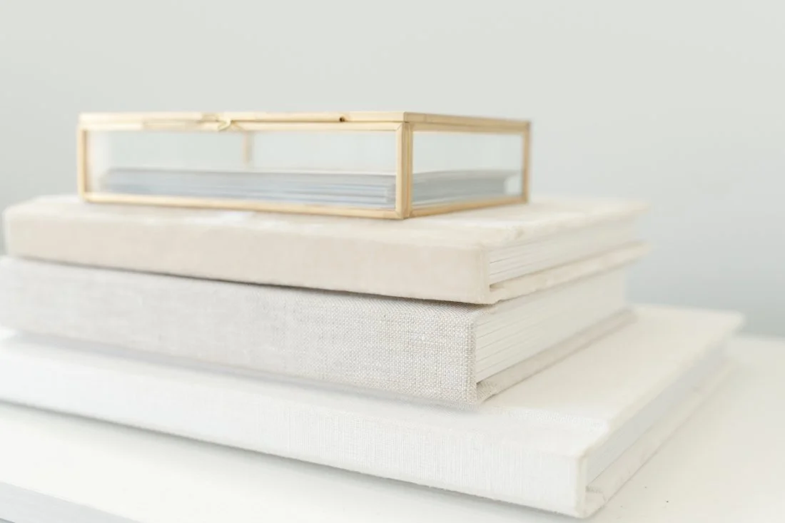 Heirloom family photo albums and artwork showcasing the client experience that helps photographers understand how to start a photography business.