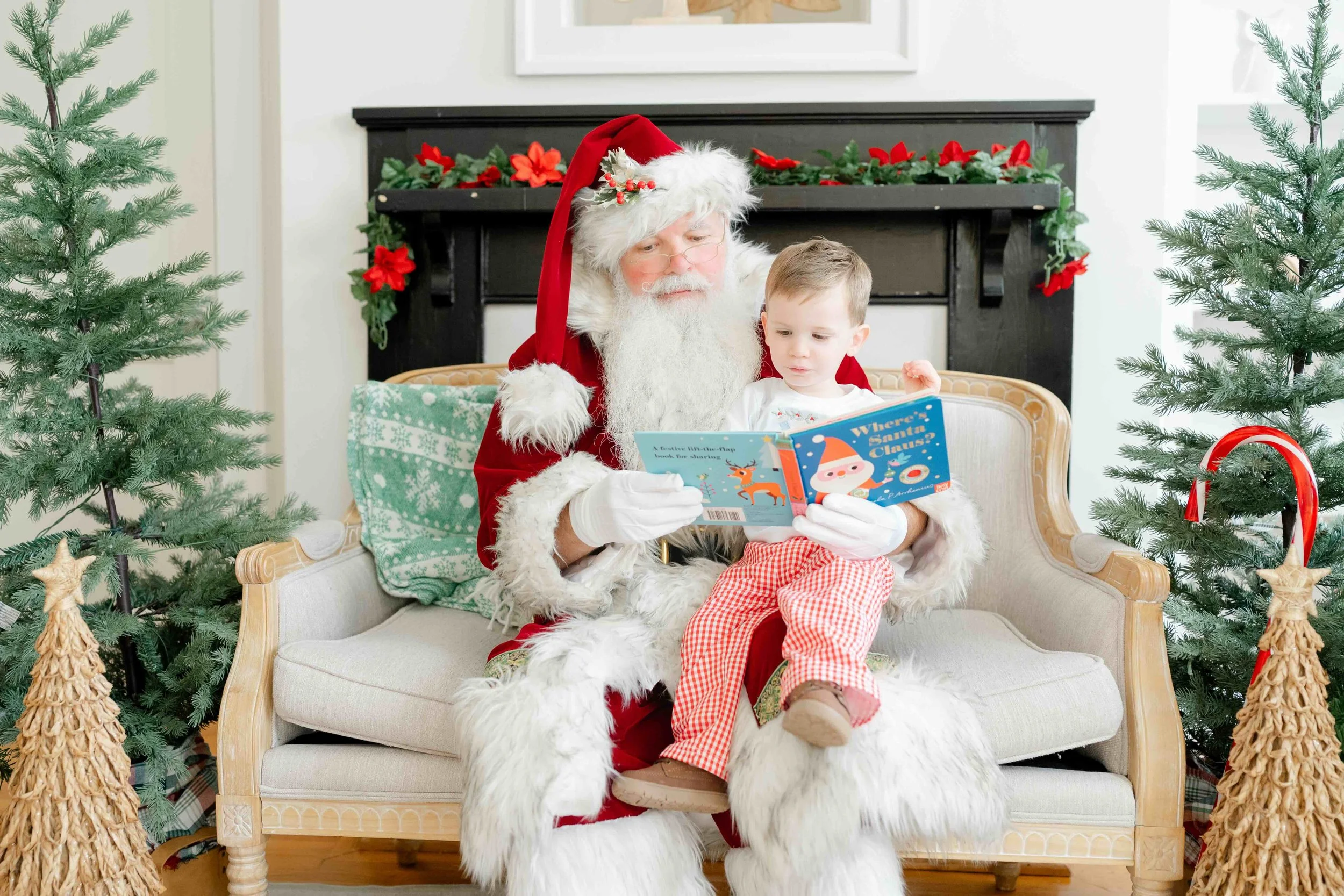Boy sitting on Santa's lap during their family Christmas Activity in Raleigh by Kelly Bullock Photography.