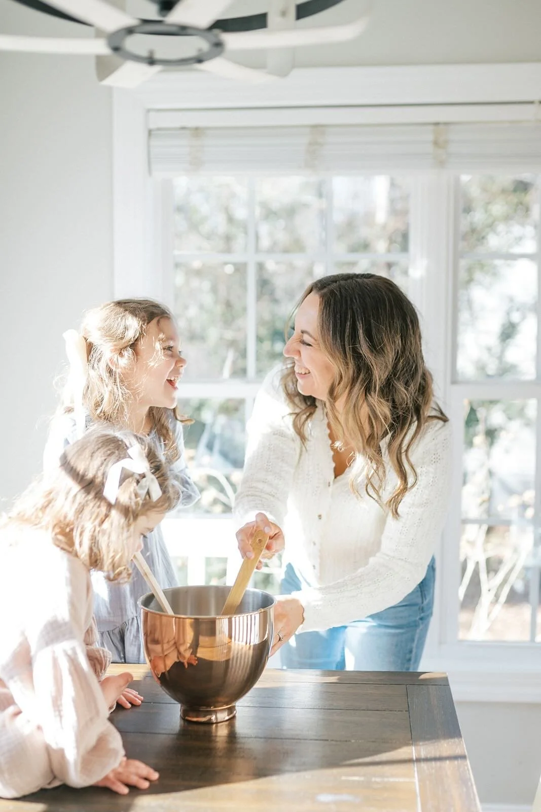 Mom baking with daughters in the kitchen - Raleigh Newborn Photographer