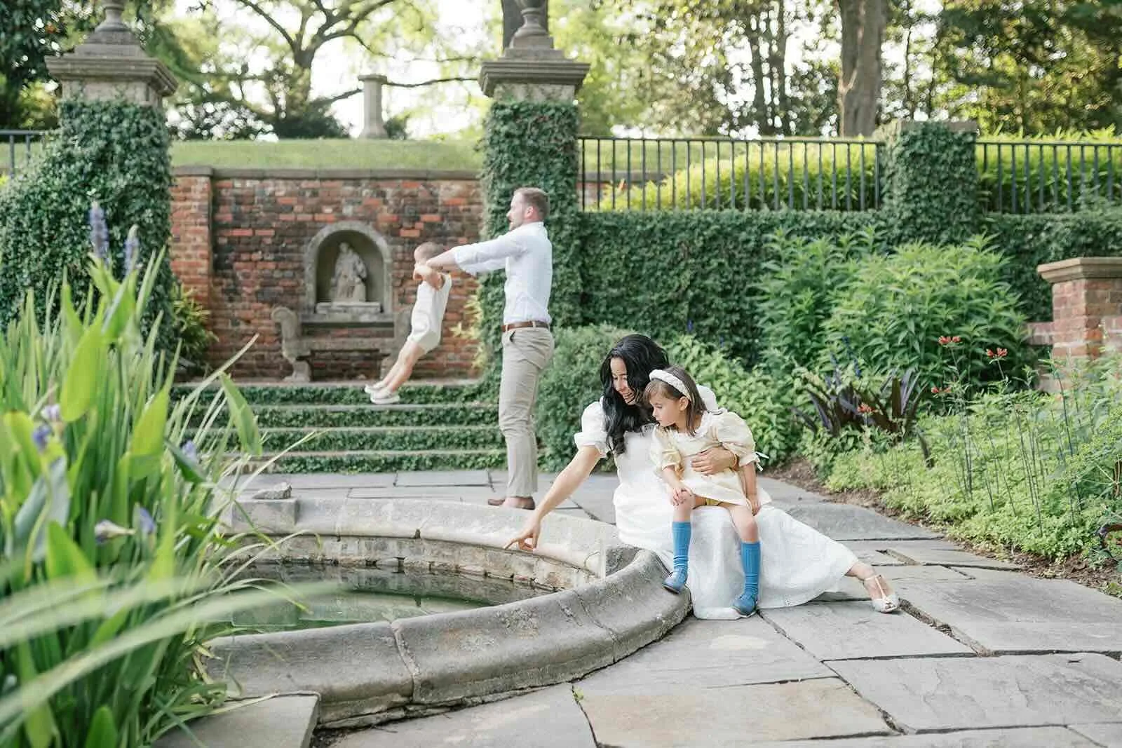 Family outside playing in a garden - Raleigh Newborn Photographer